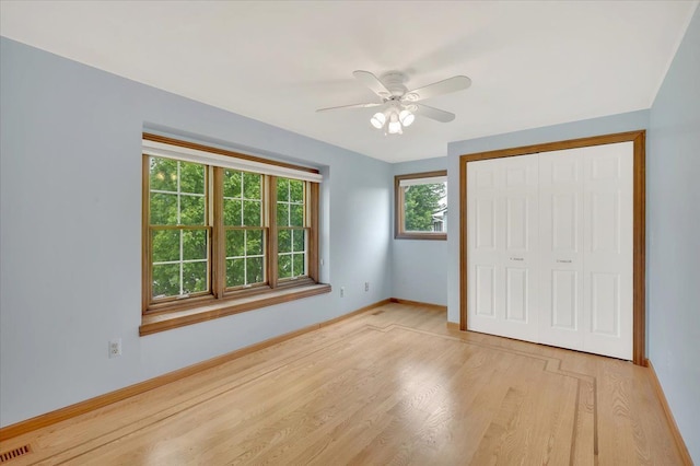 2485 Kimberly Fair St, Rochester Hills, MI 48309 - unfurnished bedroom with light wood-type flooring, a closet, baseboards, and a ceiling fan