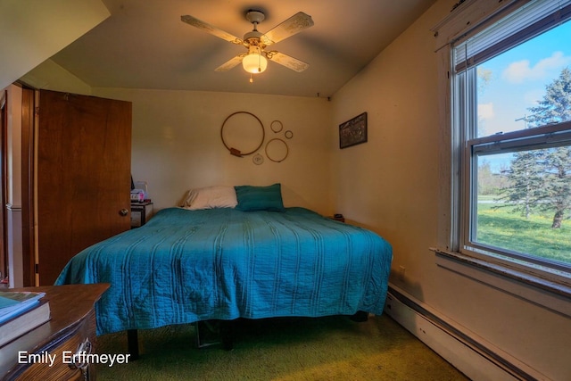 bedroom featuring a baseboard heating unit, ceiling fan, carpet flooring, and multiple windows