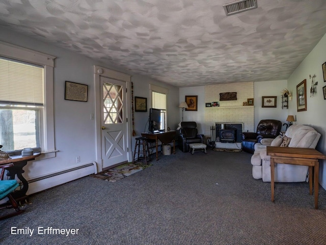 carpeted living room with visible vents and a textured ceiling