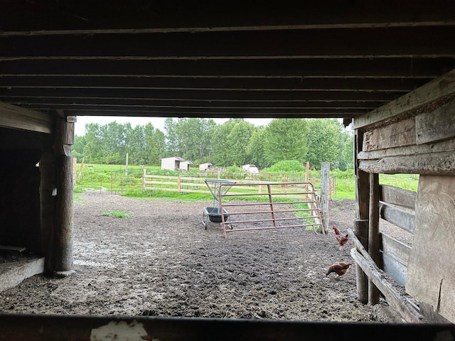 view of horse barn featuring a rural view
