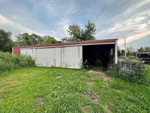view of pole building with a yard
