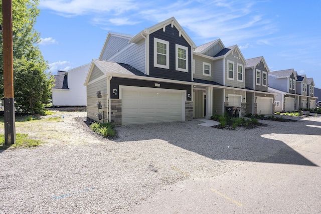 742 Ravine Ln, South Haven, MI 49090 - view of property with a garage, a residential view, driveway, and stone siding