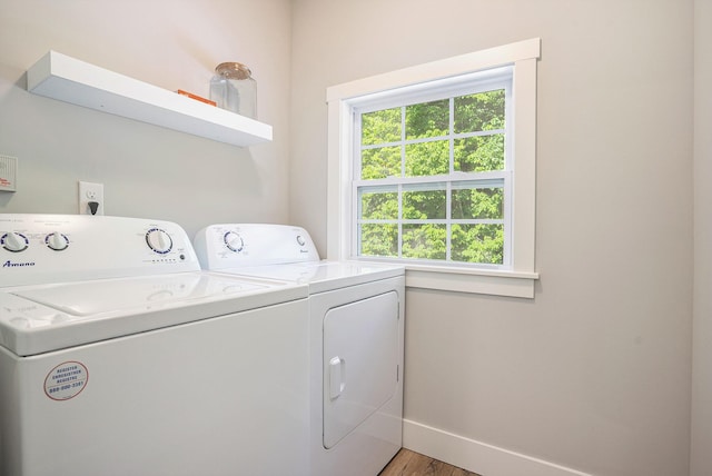 742 Ravine Ln, South Haven, MI 49090 - clothes washing area featuring light wood-style floors, baseboards, washer and dryer, and laundry area