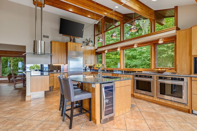5788 M 63, Coloma, MI 49038 - kitchen with beverage cooler, a high ceiling, stainless steel appliances, light tile patterned floors, and a sink