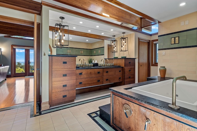 5788 M 63, Coloma, MI 49038 - kitchen with recessed lighting, dark countertops, light tile patterned floors, a sink, and pendant lighting