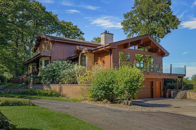 5788 M 63, Coloma, MI 49038 - chalet / cabin with an attached garage, driveway, and a chimney