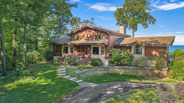 5788 M 63, Coloma, MI 49038 - craftsman-style house with a chimney, a front lawn, a porch, and board and batten siding