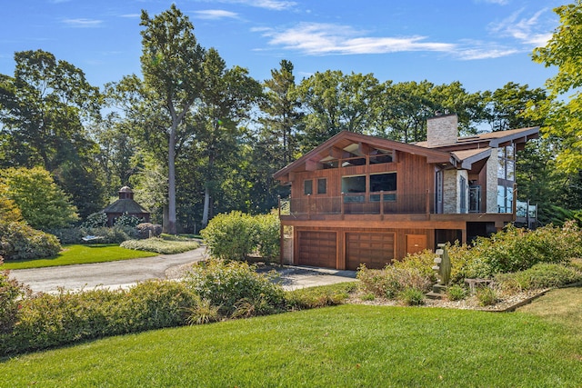 5788 M 63, Coloma, MI 49038 - back of property with driveway, a chimney, a yard, and a garage