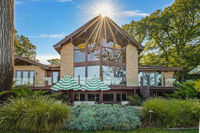 5788 M 63, Coloma, MI 49038 - back of property with a wooden deck, a sunroom, and stone siding