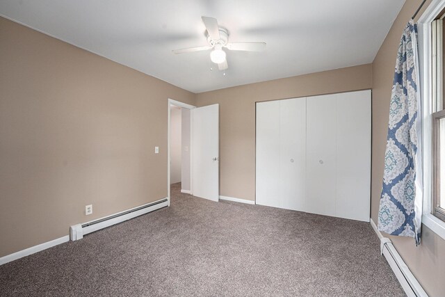 unfurnished bedroom featuring baseboard heating, carpet, a closet, and a baseboard radiator