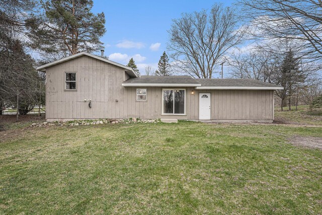 rear view of property featuring a yard