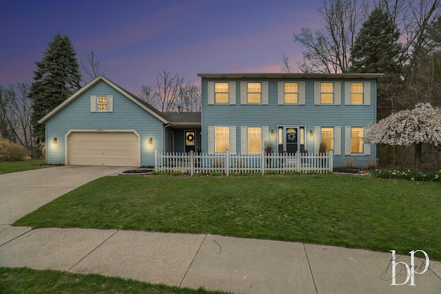 colonial inspired home with an attached garage, driveway, fence private yard, and a front yard