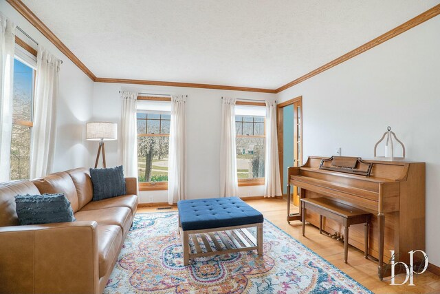 living room with light wood-style flooring, baseboards, and ornamental molding