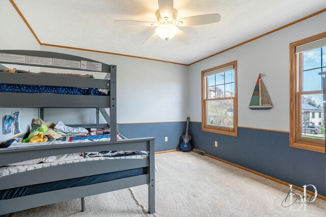 bedroom with baseboards, crown molding, carpet flooring, and multiple windows