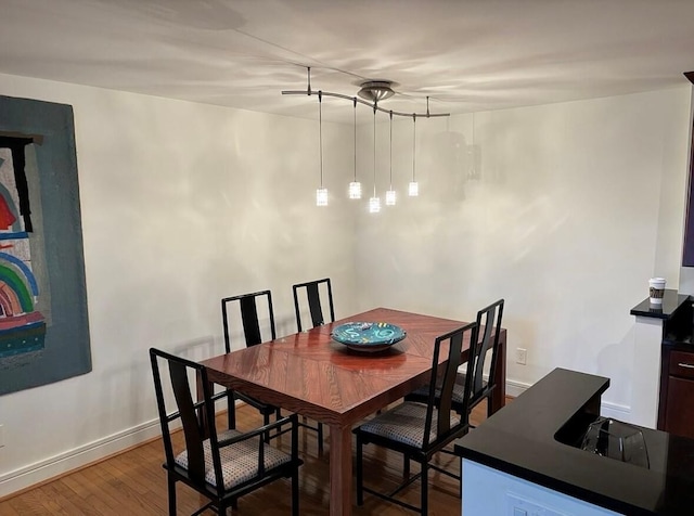 dining room featuring wood finished floors and baseboards