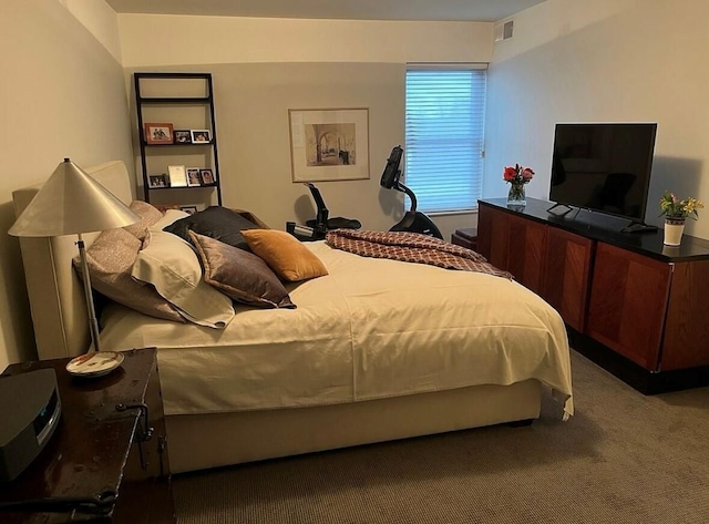carpeted bedroom featuring visible vents