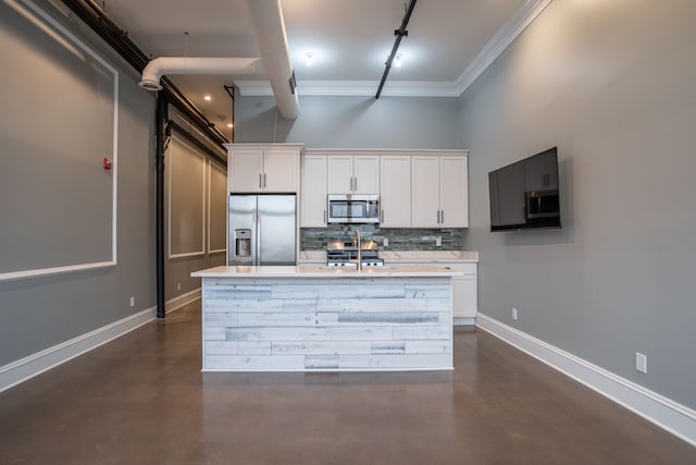 kitchen featuring finished concrete flooring, ornamental molding, appliances with stainless steel finishes, and track lighting