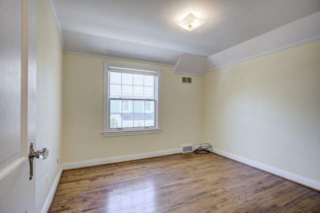 20 Oxford Blvd, Pleasant Ridge, MI 48069 - spare room featuring baseboards, visible vents, wood finished floors, and lofted ceiling