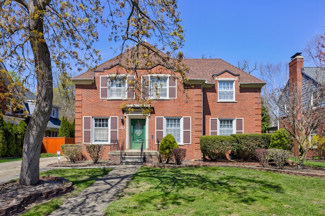 20 Oxford Blvd, Pleasant Ridge, MI 48069 - view of front of property with brick siding, fence, a shingled roof, and a front lawn