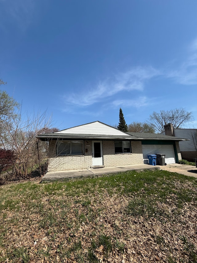 4123 Burton St, Inkster, MI 48141 - view of front facade with a front lawn, concrete driveway, brick siding, and an attached garage