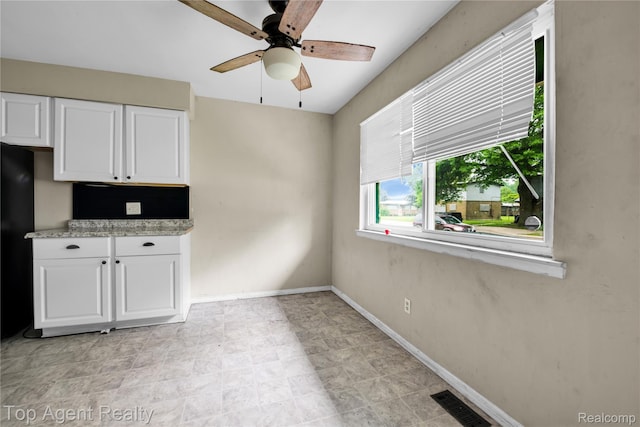 4123 Burton St, Inkster, MI 48141 - unfurnished dining area featuring a ceiling fan and baseboards