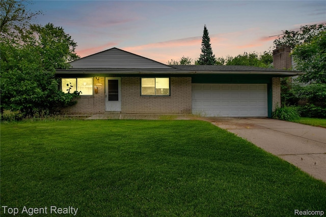 4123 Burton St, Inkster, MI 48141 - view of front of house with driveway, an attached garage, brick siding, and a front lawn