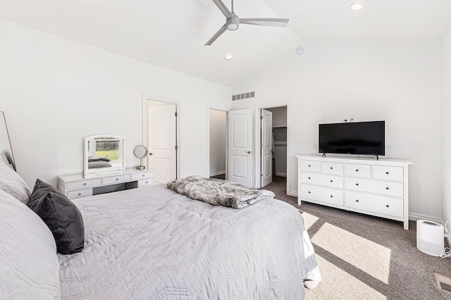 bedroom with visible vents, dark carpet, a walk in closet, high vaulted ceiling, and a ceiling fan