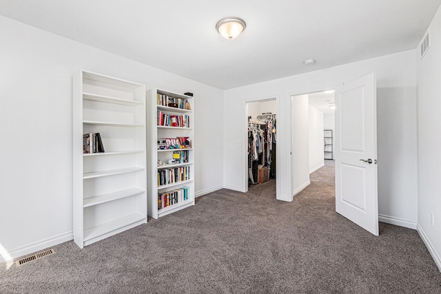 carpeted bedroom featuring baseboards, visible vents, and a closet