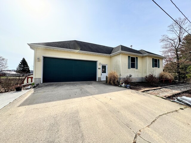 single story home featuring driveway and a garage
