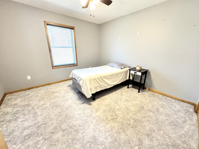 carpeted bedroom featuring a ceiling fan and baseboards