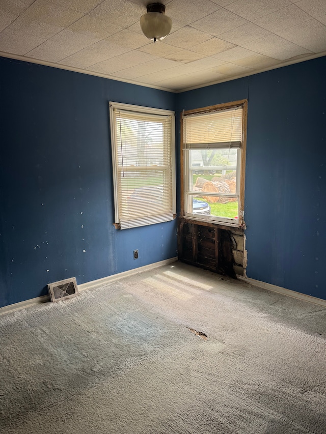 carpeted empty room featuring baseboards