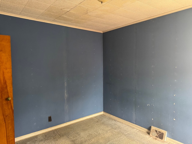 carpeted empty room featuring baseboards