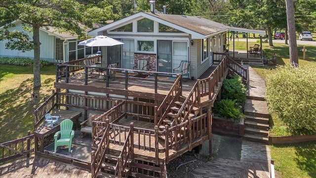 back of property featuring a wooden deck and stairs