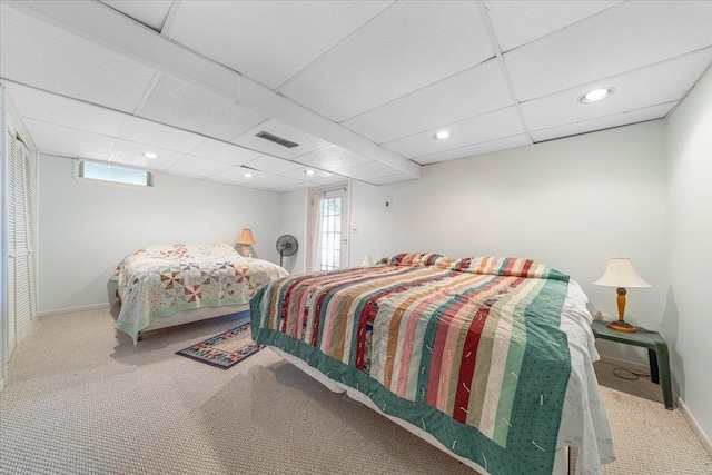 carpeted bedroom with baseboards, visible vents, and multiple windows