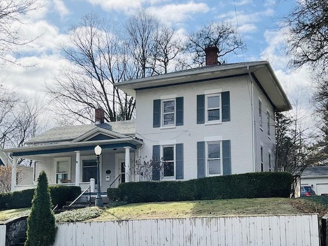 323 N Marshall Ave, Marshall, MI 49068 - view of front facade featuring a chimney, covered porch, and a front yard