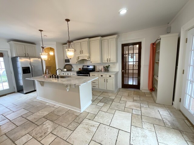 323 N Marshall Ave, Marshall, MI 49068 - kitchen featuring a breakfast bar, stone tile flooring, a sink, and appliances with stainless steel finishes