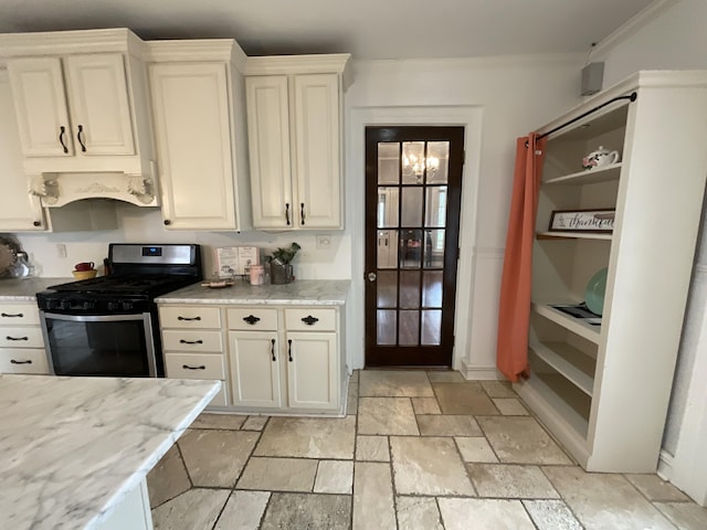 323 N Marshall Ave, Marshall, MI 49068 - kitchen featuring stone tile floors, stainless steel range with gas stovetop, light stone counters, and crown molding