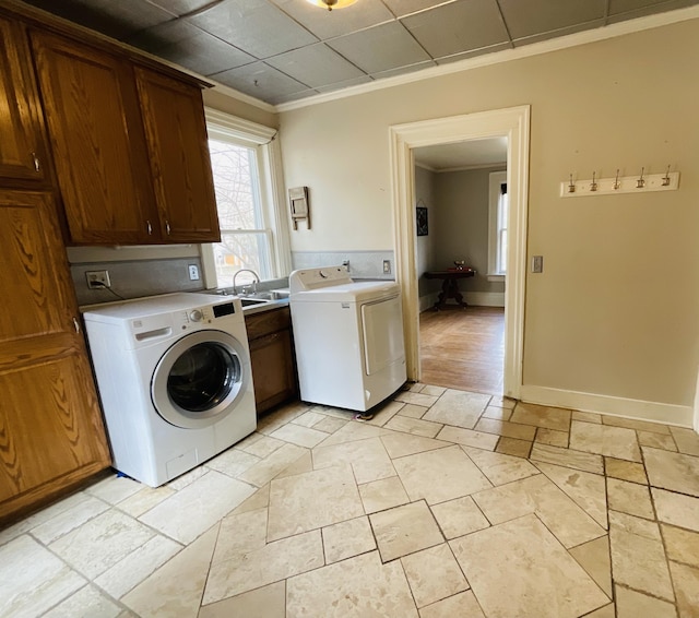 323 N Marshall Ave, Marshall, MI 49068 - washroom featuring ornamental molding, a sink, baseboards, washer and dryer, and cabinet space