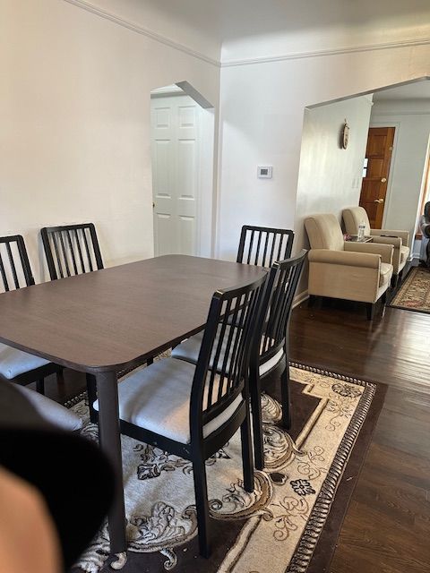23226 Edward St, Dearborn, MI 48128 - dining area featuring arched walkways, wood finished floors, and ornamental molding