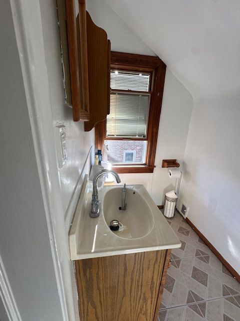 23226 Edward St, Dearborn, MI 48128 - bathroom with a sink and lofted ceiling