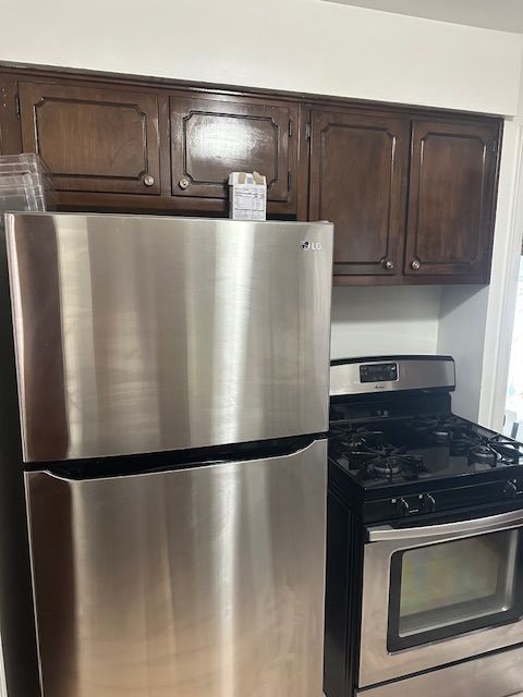 23226 Edward St, Dearborn, MI 48128 - kitchen with appliances with stainless steel finishes and dark brown cabinetry