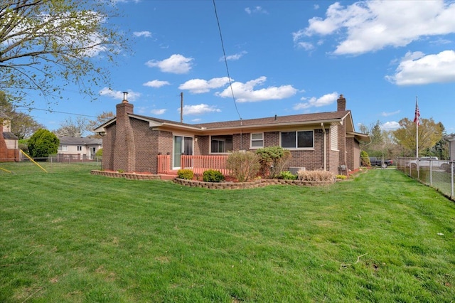 2946 Athena Dr, Troy, MI 48083 - back of house featuring a lawn, brick siding, a chimney, and a fenced backyard