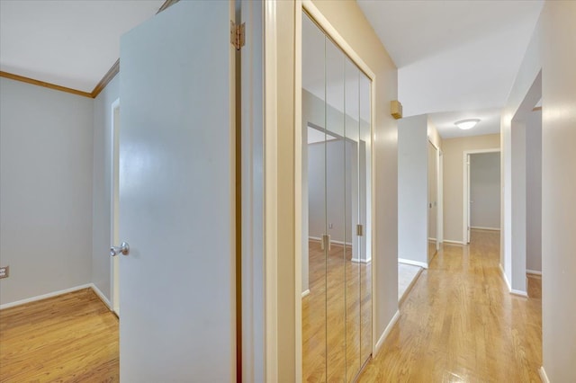 2946 Athena Dr, Troy, MI 48083 - hallway featuring light wood-type flooring, ornamental molding, and baseboards