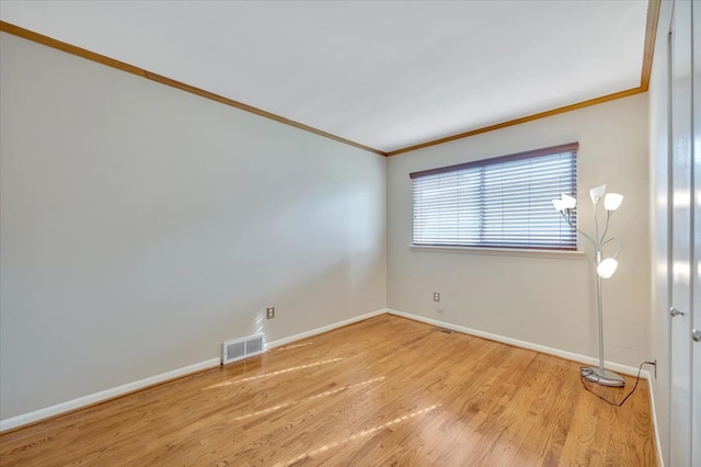 2946 Athena Dr, Troy, MI 48083 - empty room with crown molding, baseboards, light wood-type flooring, and visible vents