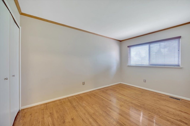 2946 Athena Dr, Troy, MI 48083 - empty room with crown molding, baseboards, visible vents, and light wood-style flooring