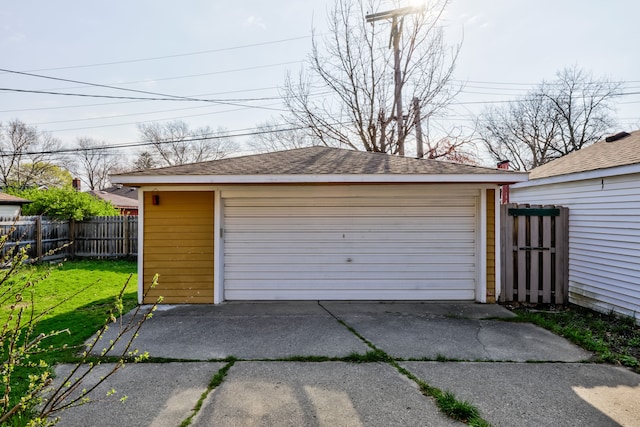 detached garage featuring fence