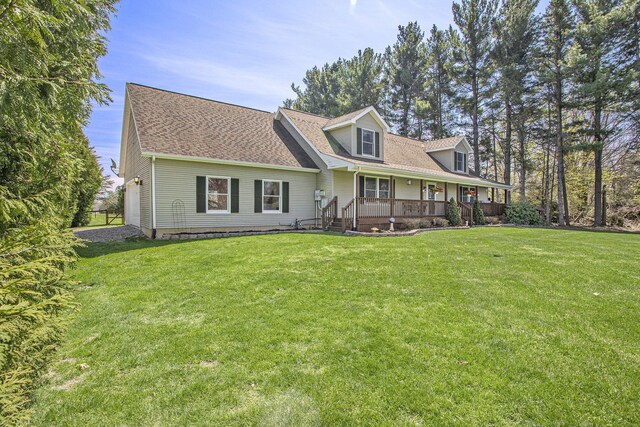 cape cod house featuring a front lawn, a porch, and a shingled roof