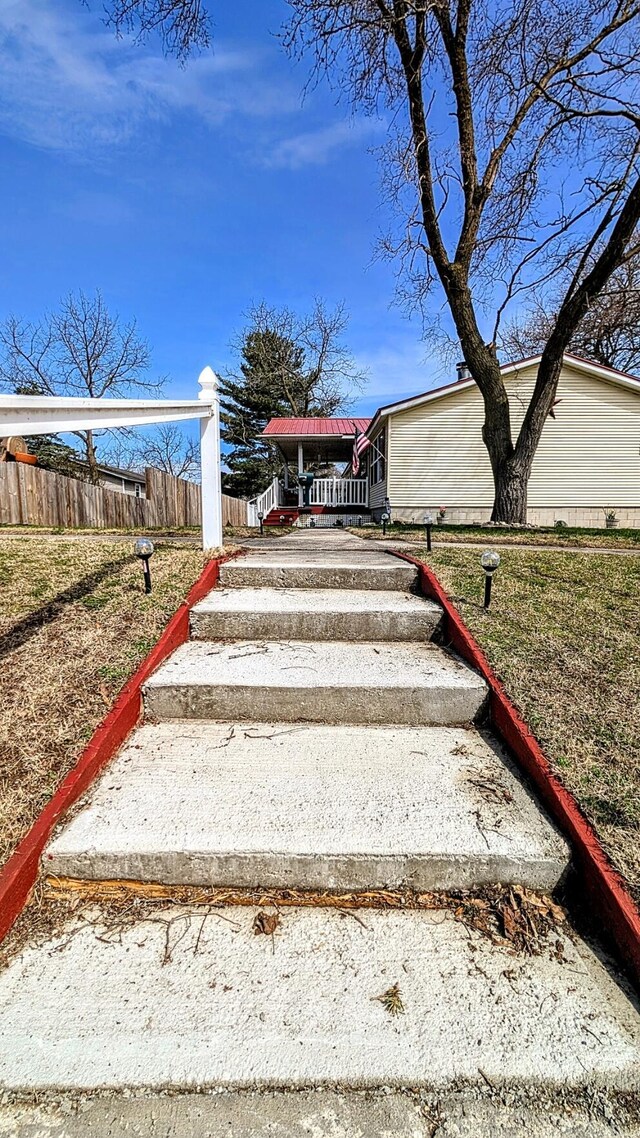 view of yard featuring a porch and fence