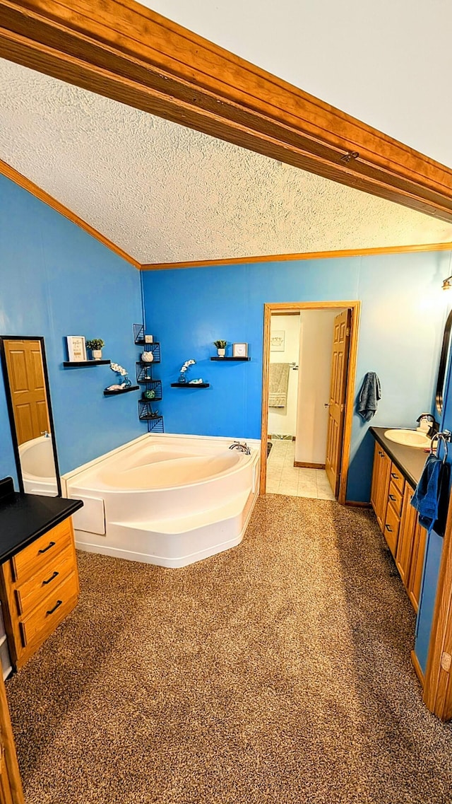 bathroom featuring a textured ceiling, carpet, and a garden tub