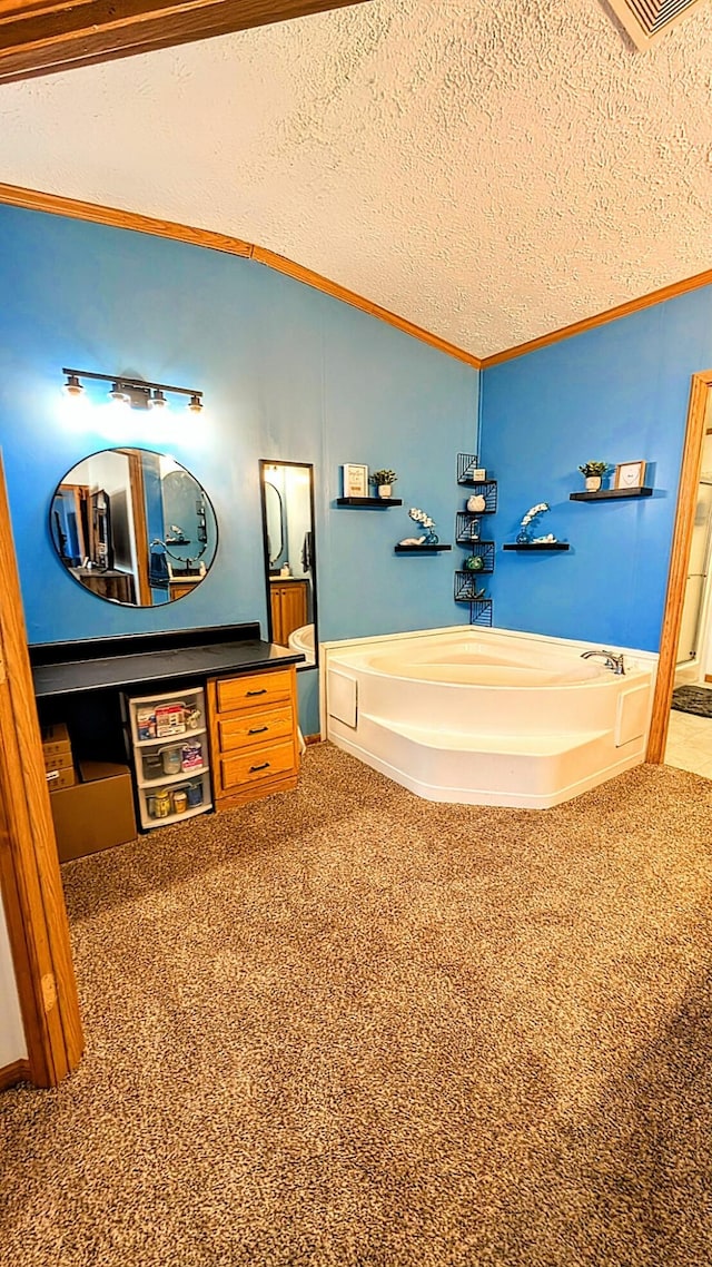 bathroom featuring a garden tub, vaulted ceiling, crown molding, and a textured ceiling
